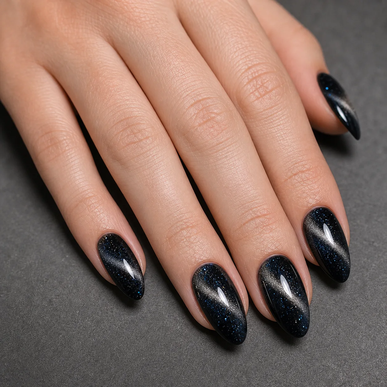 Black galaxy cat eye nails with silver magnetic streaks