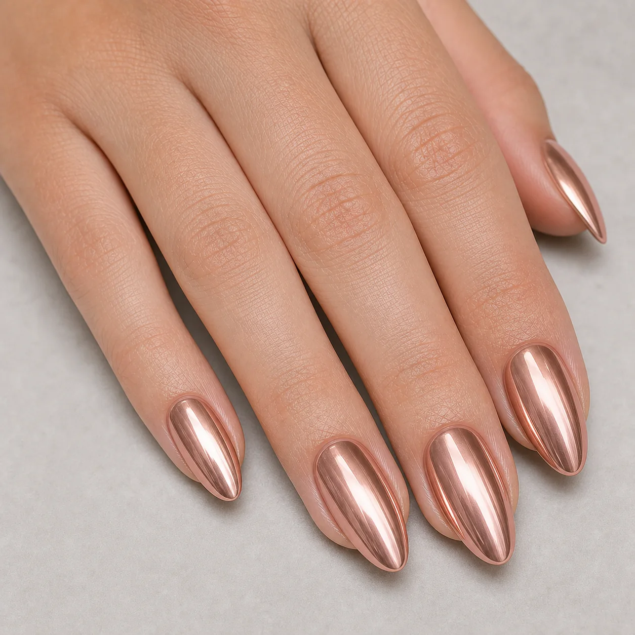Rose gold chrome nails with warm metallic shine